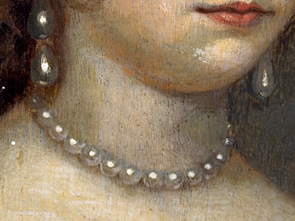 A 17th-century oil portrait painting on an oak panel depicting a woman with dark ringlets and pearl jewellery in a gadrooned gold leaf frame. View XI