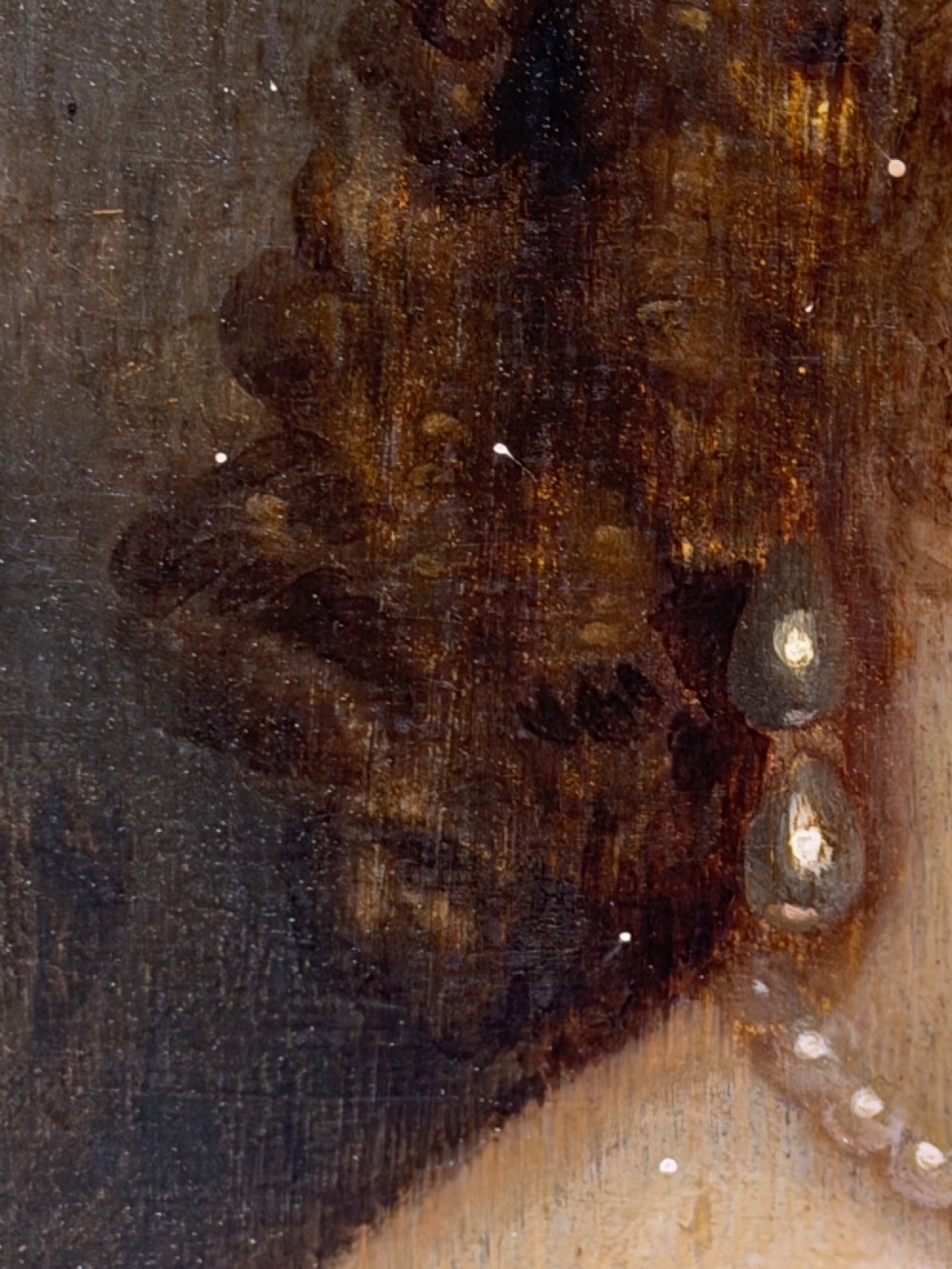 A 17th-century oil portrait painting on an oak panel depicting a woman with dark ringlets and pearl jewellery in a gadrooned gold leaf frame. View XIII