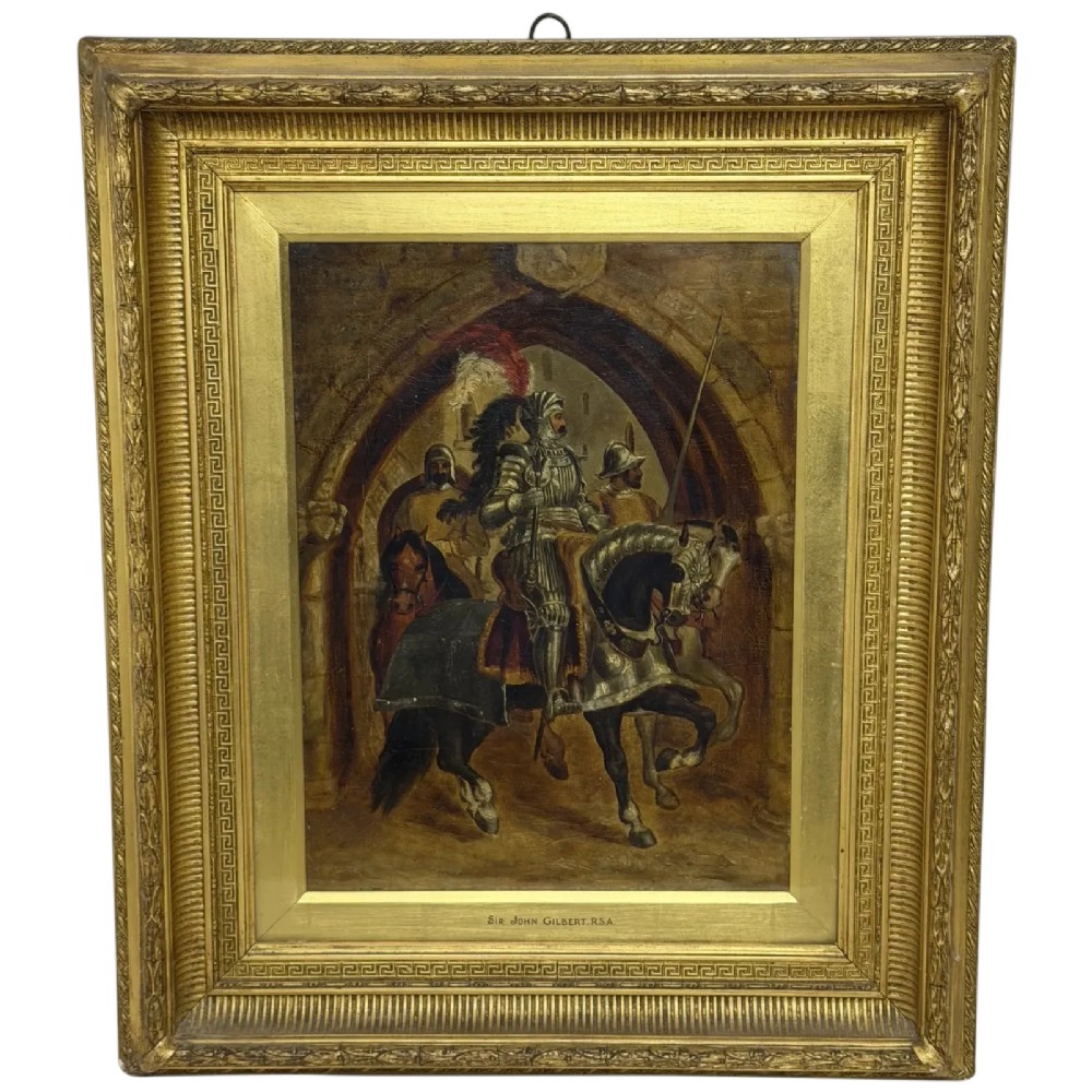 An antique oil painting depicting a knight in full armour riding a horse beneath a stone archway, framed in an ornate gilded wood frame.