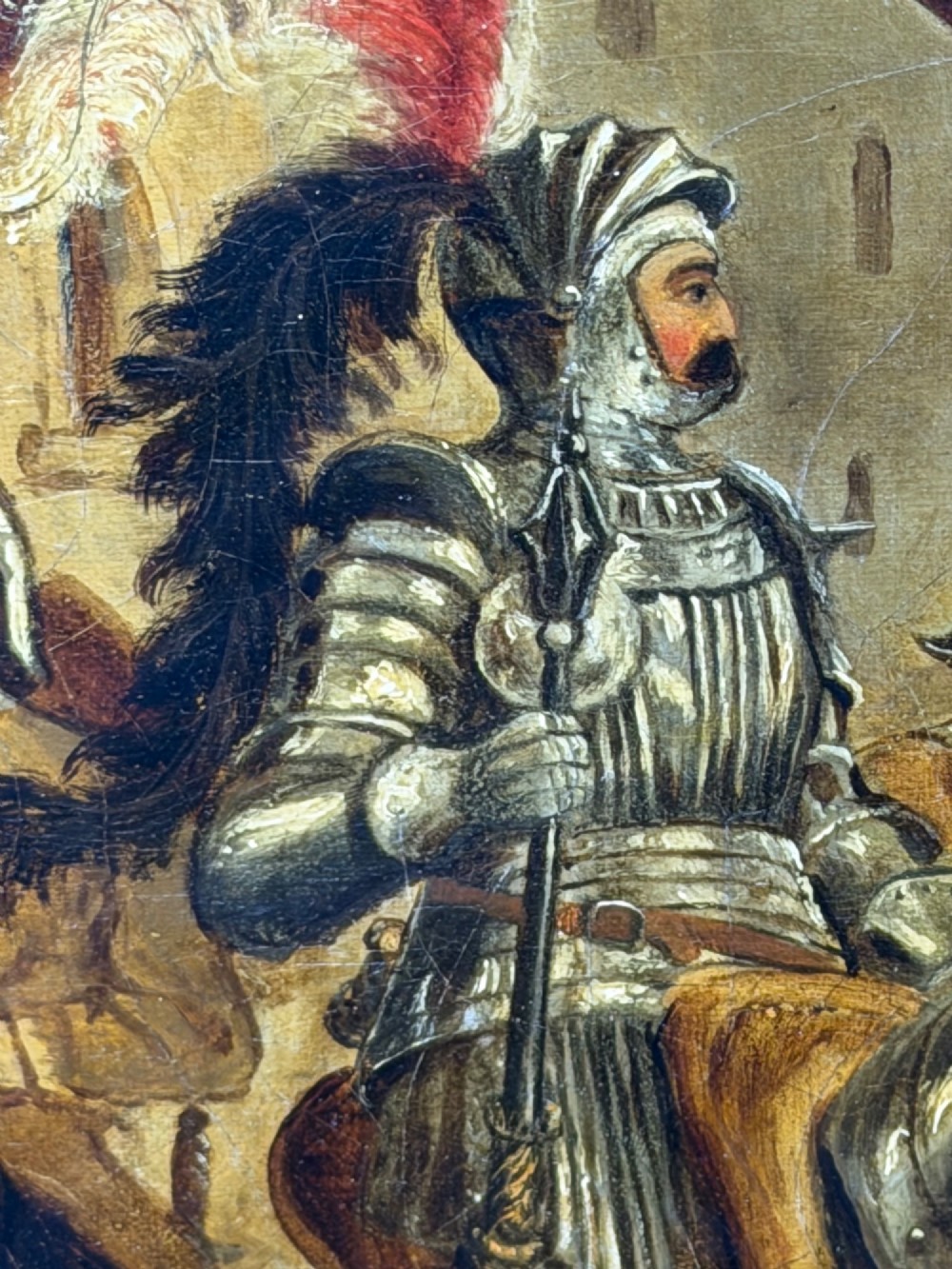 An antique oil painting depicting a knight in full armour riding a horse beneath a stone archway, framed in an ornate gilded wood frame. View VI
