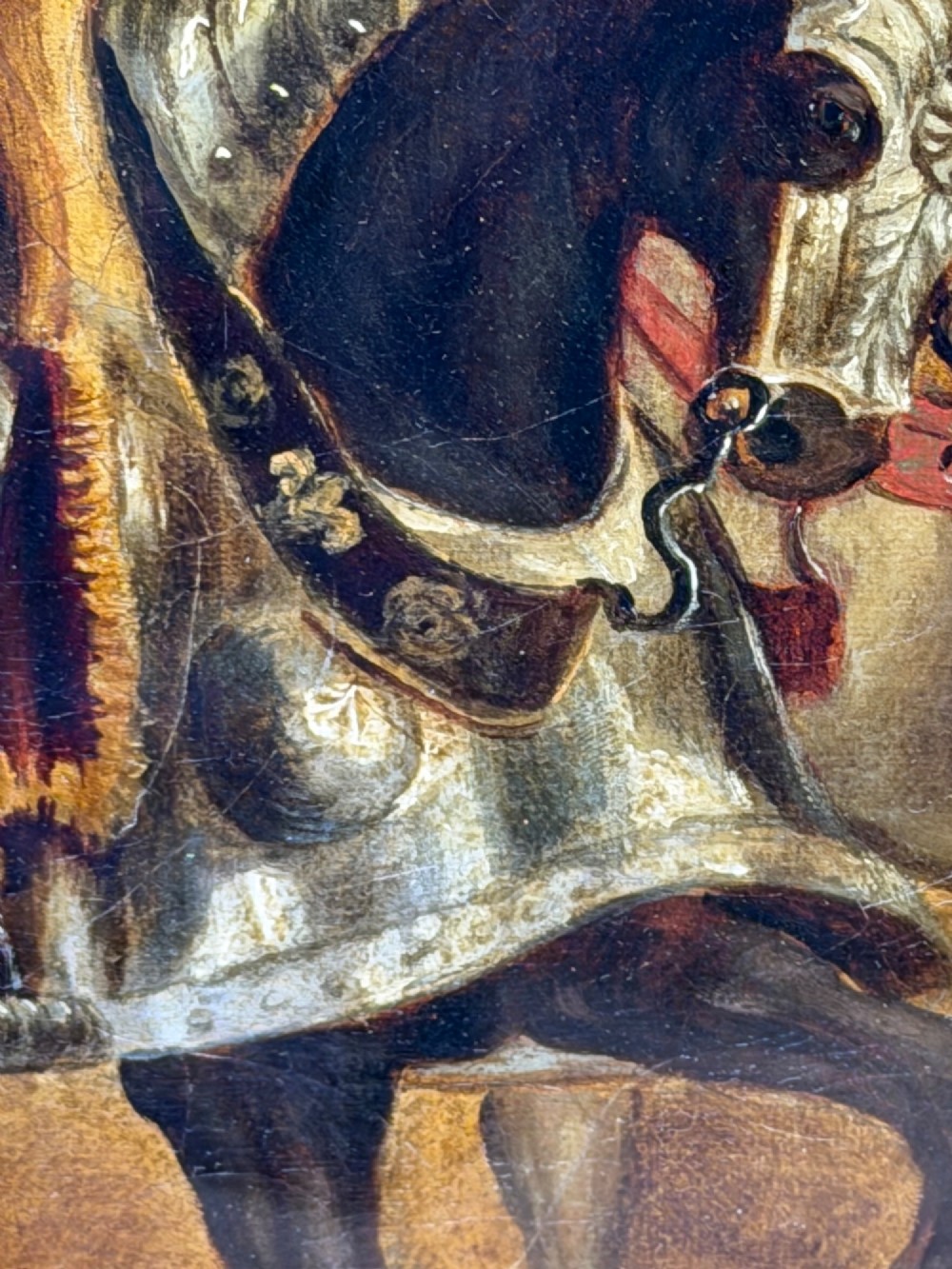 An antique oil painting depicting a knight in full armour riding a horse beneath a stone archway, framed in an ornate gilded wood frame. View VIII