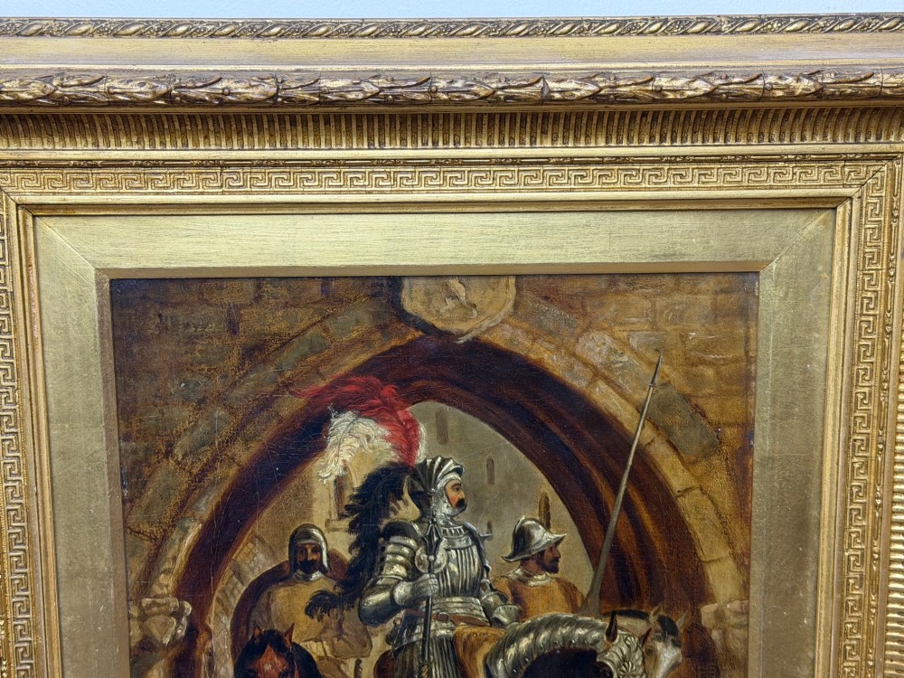 An antique oil painting depicting a knight in full armour riding a horse beneath a stone archway, framed in an ornate gilded wood frame. View X