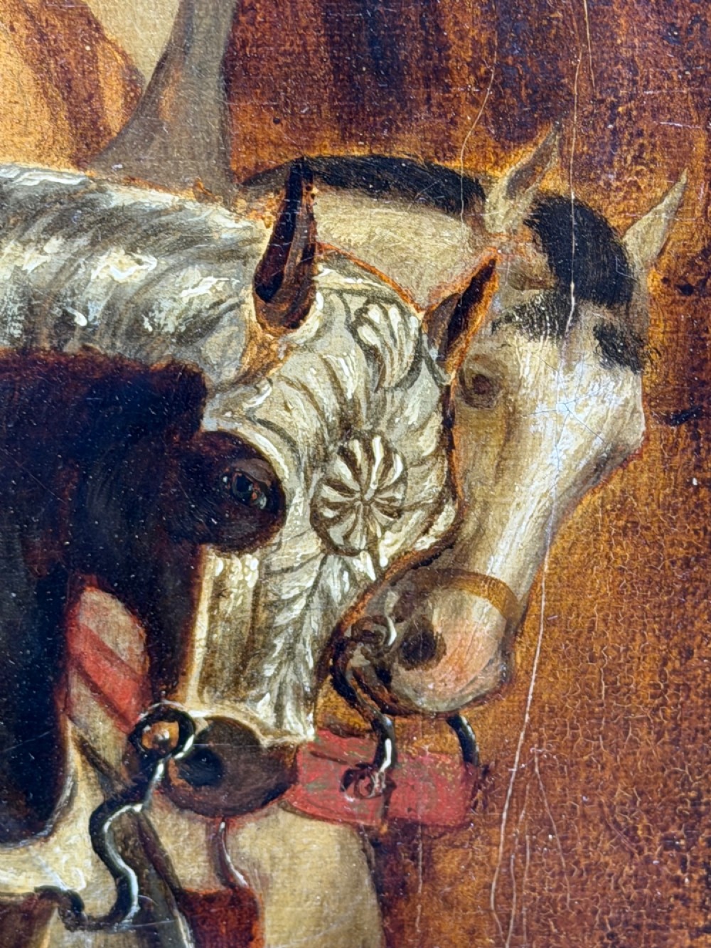 An antique oil painting depicting a knight in full armour riding a horse beneath a stone archway, framed in an ornate gilded wood frame. View XI