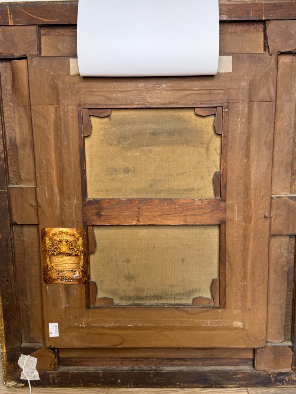An antique oil painting depicting a knight in full armour riding a horse beneath a stone archway, framed in an ornate gilded wood frame. View XIV