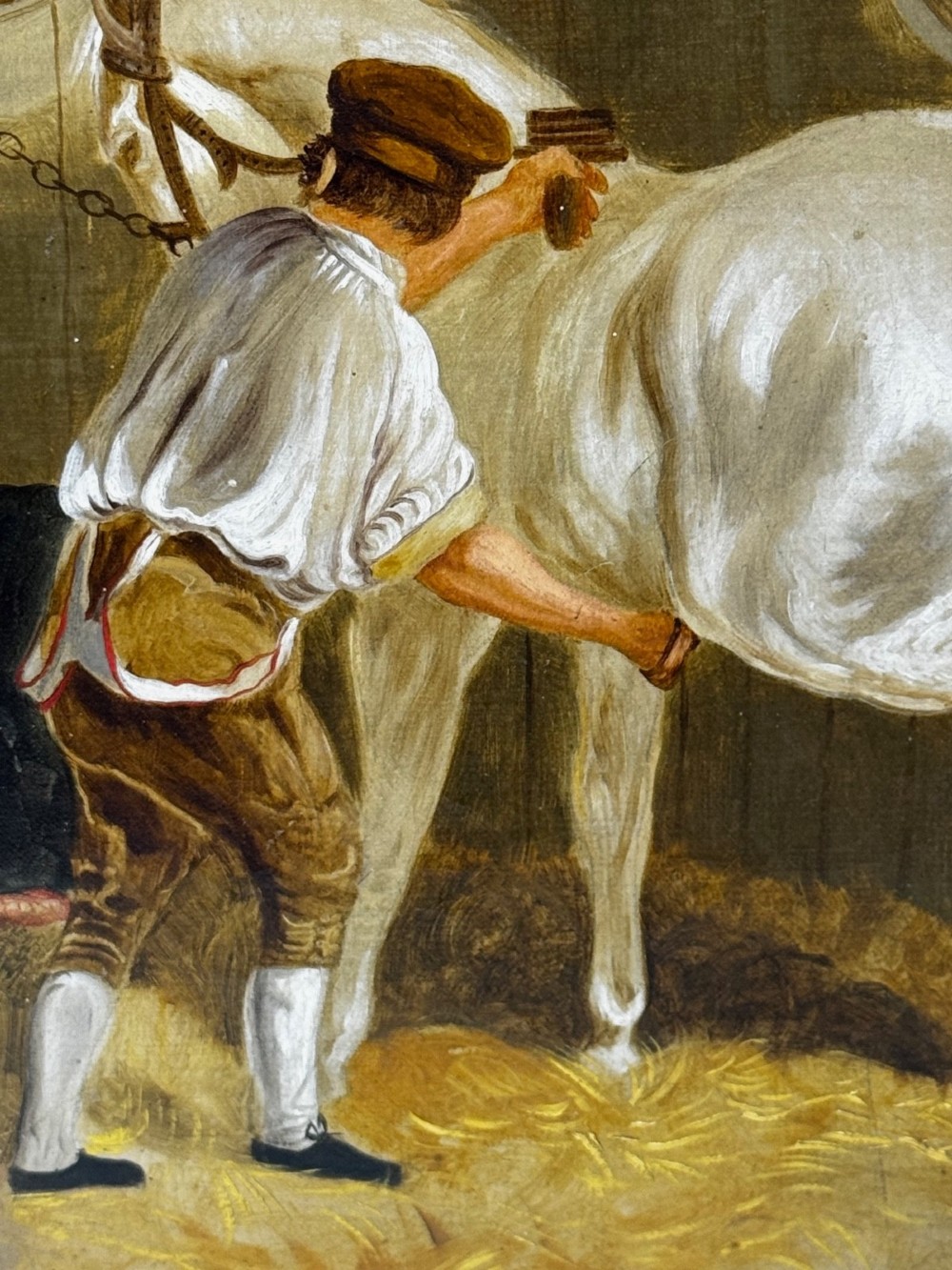 A horizontal oil painting depicting grooms tending to horses inside a stable block, housed within a fluted gilt wood frame. View V