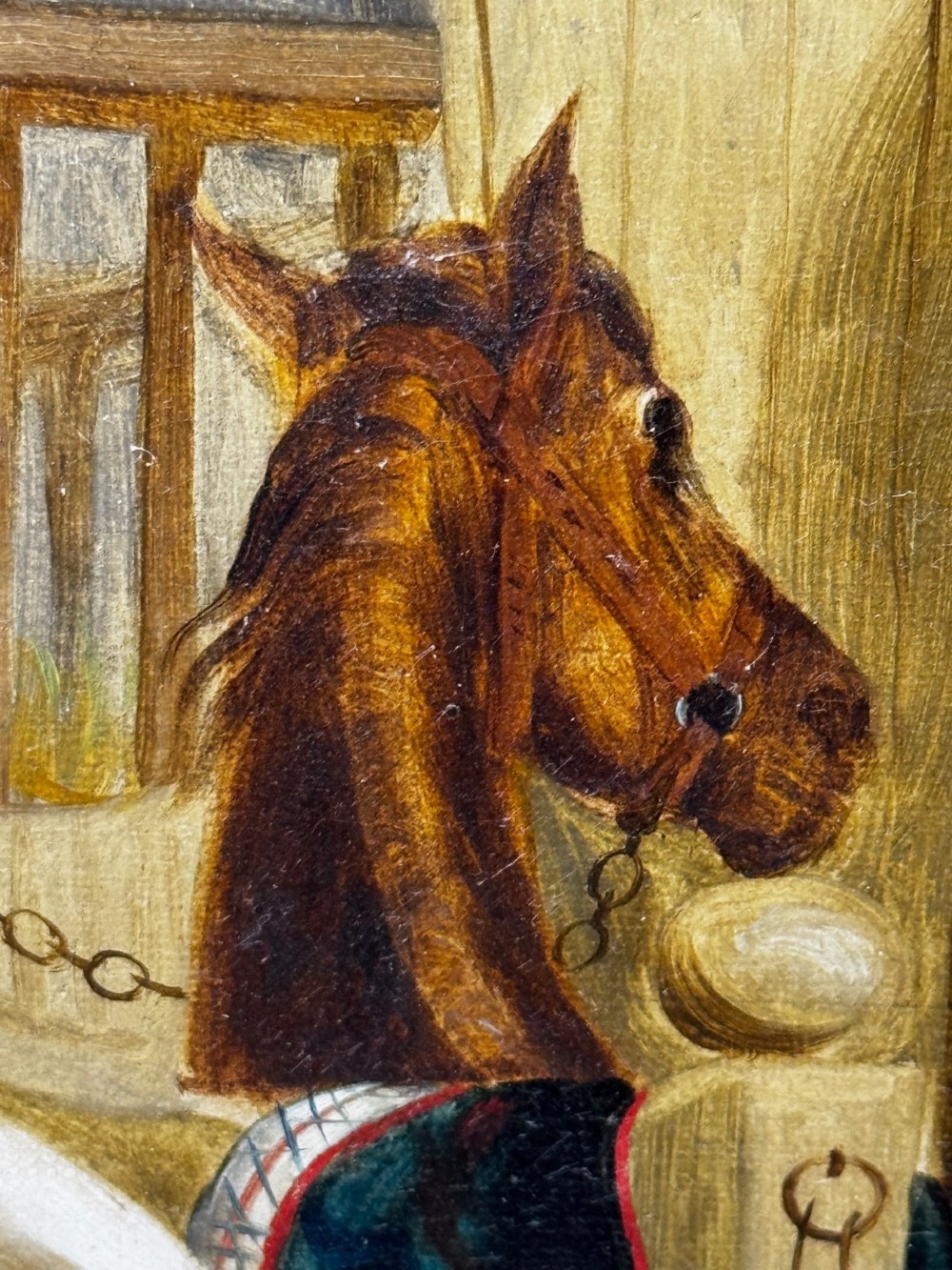 A horizontal oil painting depicting grooms tending to horses inside a stable block, housed within a fluted gilt wood frame. View XI
