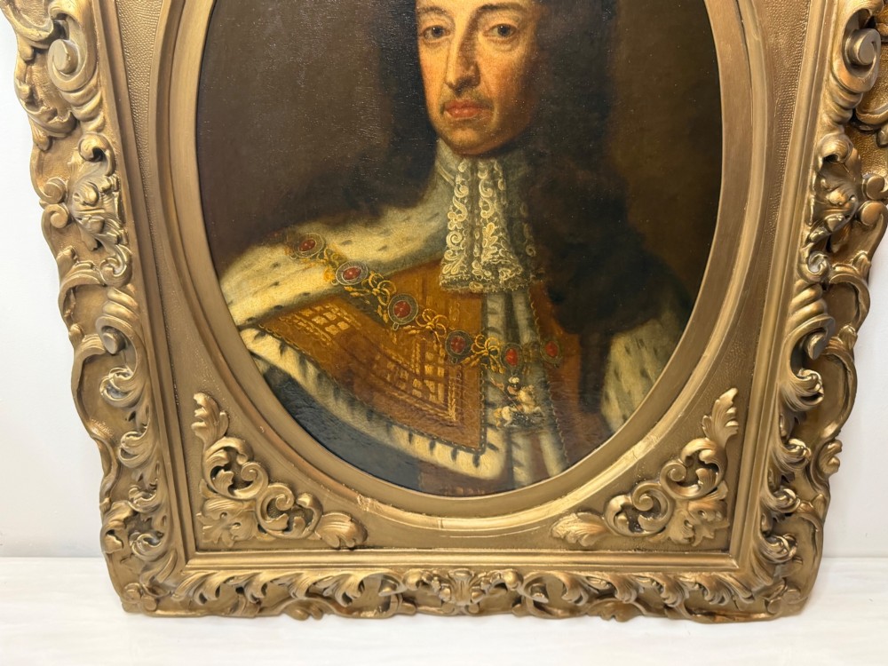An 18th-century oil painting depicting King William III in a curled wig and ermine cloak, set within an oval aperture inside an ornate rectangular gold carved frame. View II
