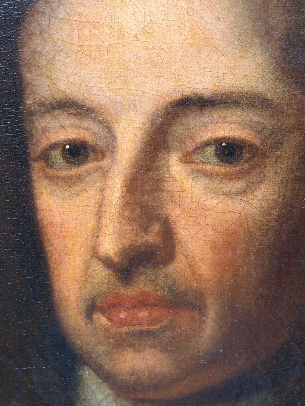 An 18th-century oil painting depicting King William III in a curled wig and ermine cloak, set within an oval aperture inside an ornate rectangular gold carved frame. View IX
