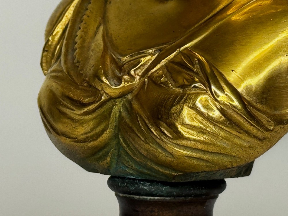 A 19th-century gilt bronze bust portrait of Diana de Poitiers featuring an ornate hairstyle and classical drapery, mounted on a dark socle and square variegated marble base. View XIV
