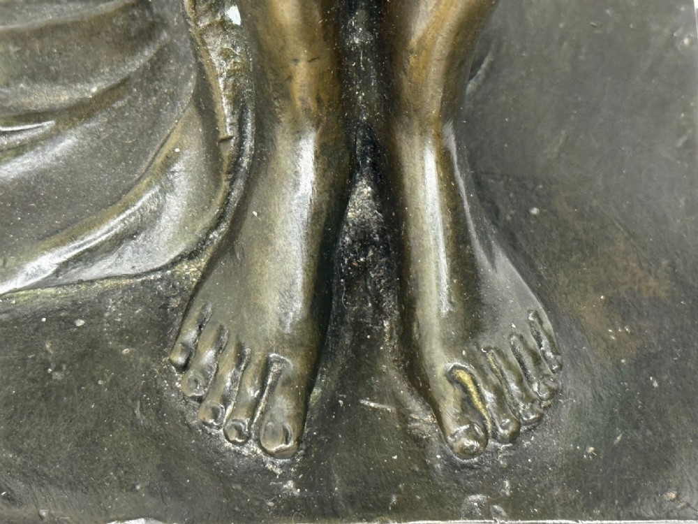 A dark brown patinated French bronze sculpture depicting a standing female nude draped in flowing fabric, mounted on a dark marble base. View IX