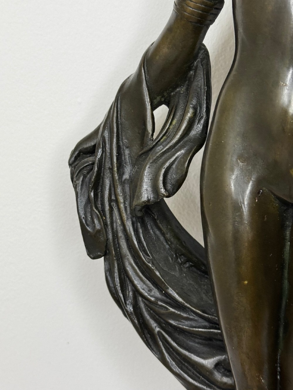 A dark brown patinated French bronze sculpture depicting a standing female nude draped in flowing fabric, mounted on a dark marble base. View XI