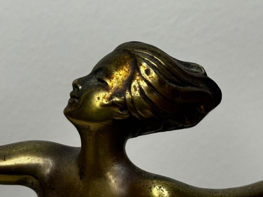 An Art Deco bronze sculpture depicting a dancer with draped fabric, mounted on a green onyx pedestal base. View II