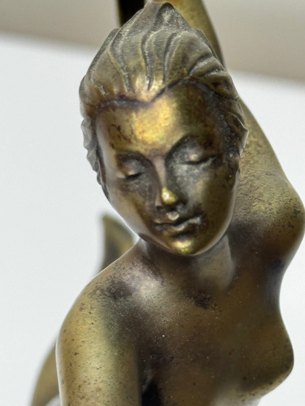 An Art Deco bronze sculpture depicting a dancer with draped fabric, mounted on a green onyx pedestal base. View VIII