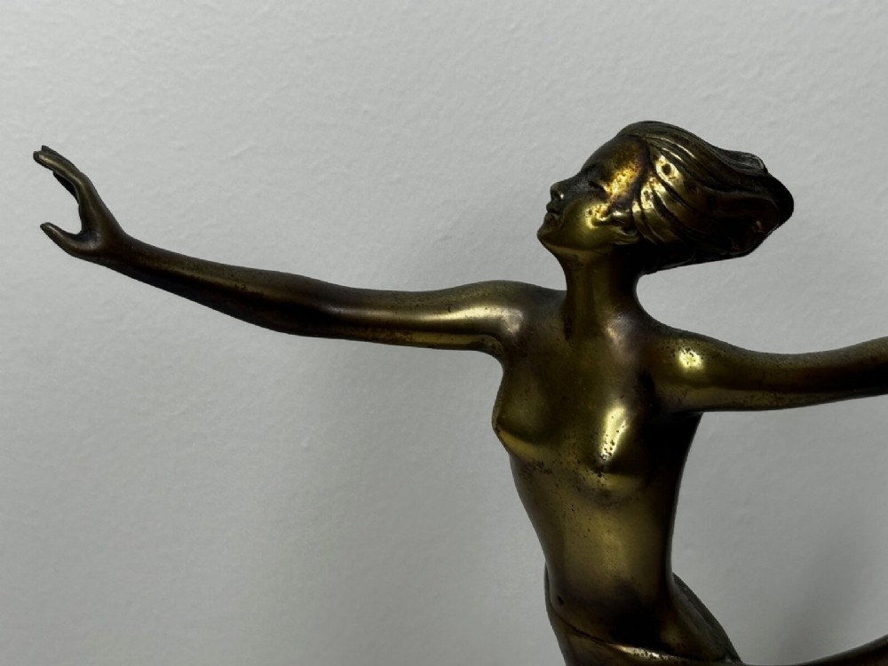 An Art Deco bronze sculpture depicting a dancer with draped fabric, mounted on a green onyx pedestal base. View XI