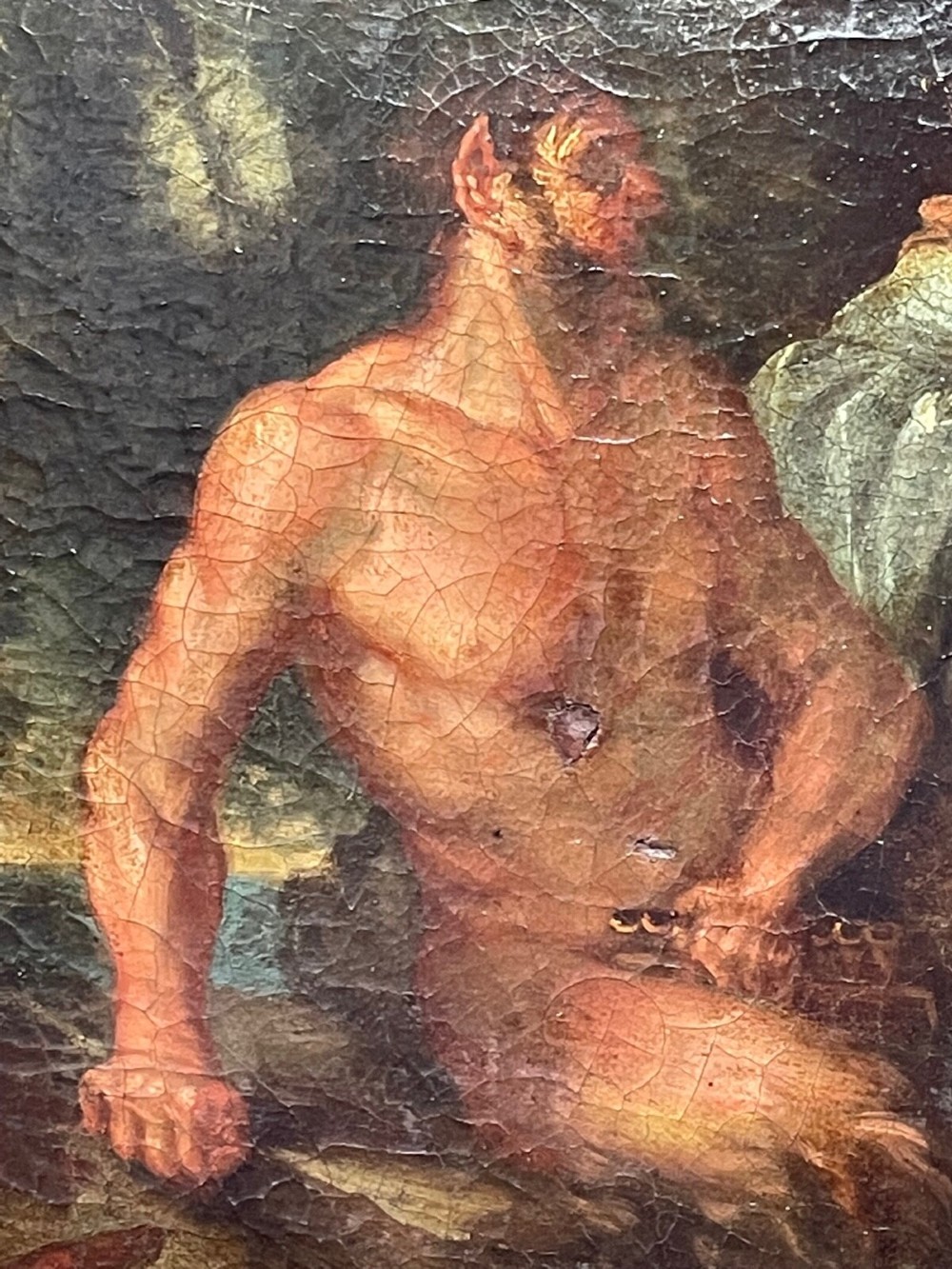 An 18th-century oil painting depicting classical figures in a wooded landscape, housed inside a carved gold giltwood frame. View X