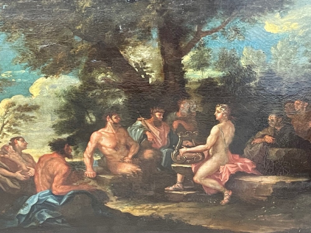 An 18th-century oil painting depicting classical figures in a wooded landscape, housed inside a carved gold giltwood frame. View XIII