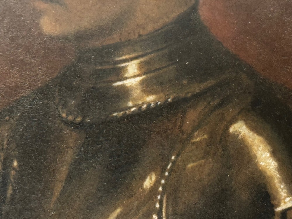 An antique profile portrait painting of a man wearing full steel armour, set within an ornate gilded frame decorated with carved shell and scroll motifs. View XIII
