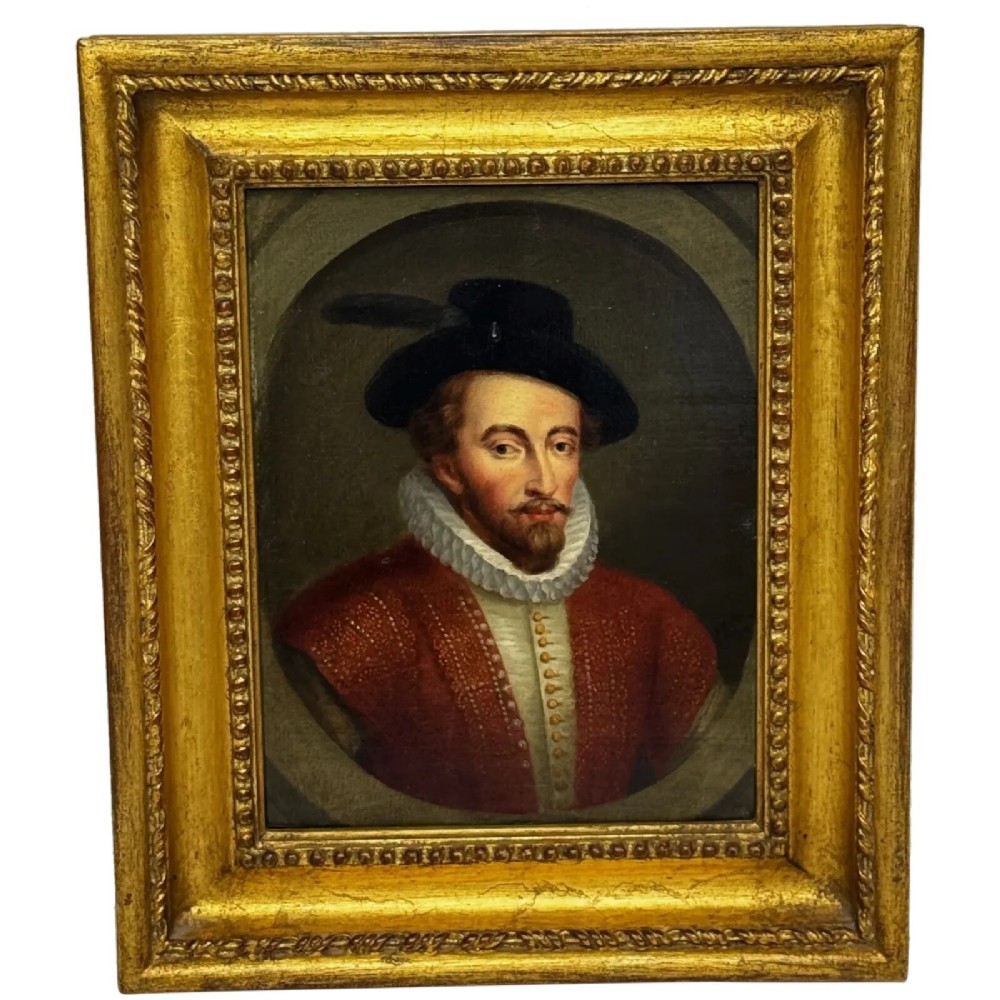 An 18th-century oil portrait of a man in a black hat, ruff collar, and crimson doublet set inside a carved gold-gilded frame.