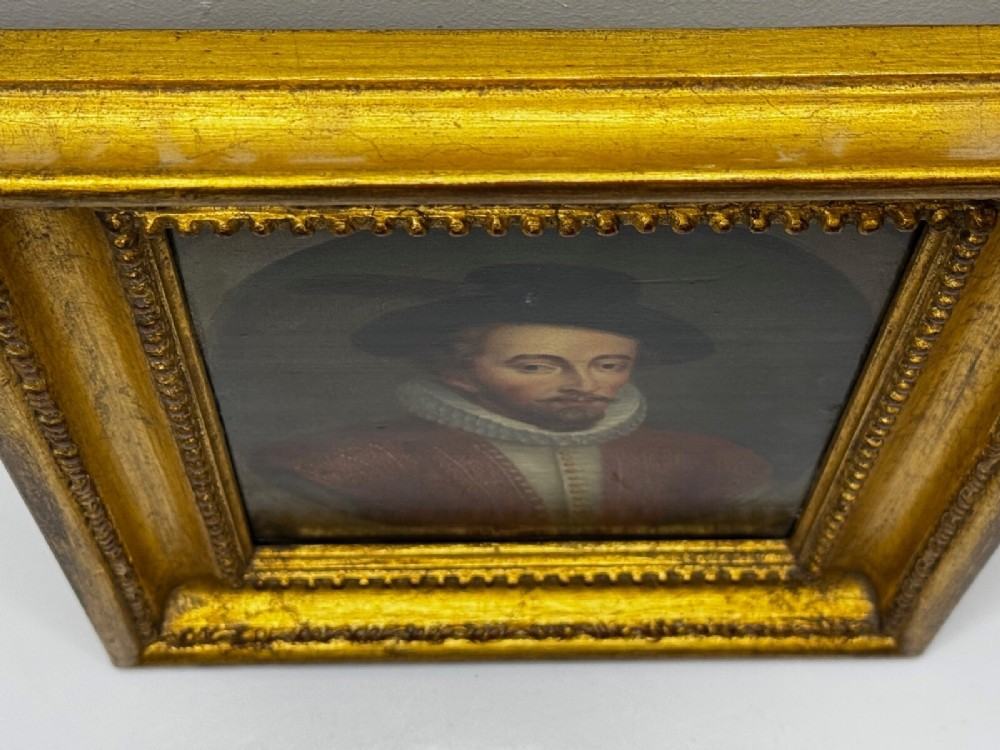 An 18th-century oil portrait of a man in a black hat, ruff collar, and crimson doublet set inside a carved gold-gilded frame. View VIII