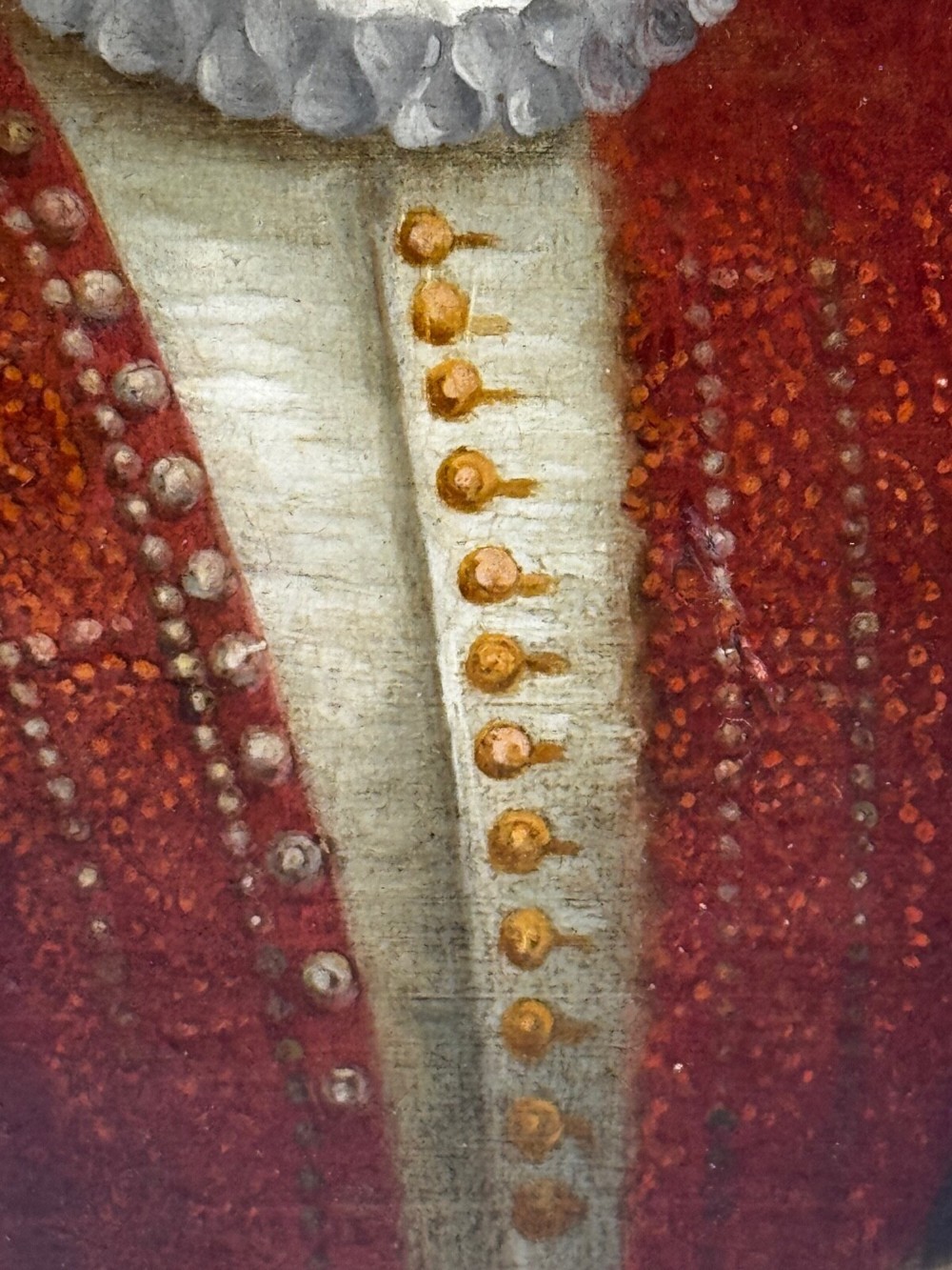 An 18th-century oil portrait of a man in a black hat, ruff collar, and crimson doublet set inside a carved gold-gilded frame. View XII