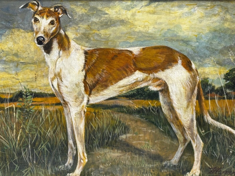 An antique Edwardian oil painting depicting a tan and white lurcher dog in a landscape, set within an ornate gilded frame. View VIII