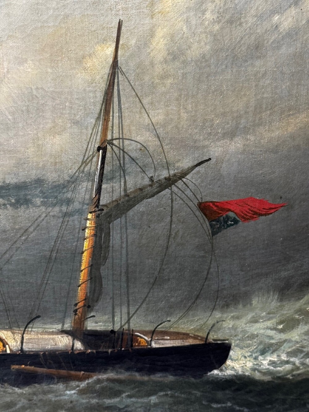 A late Victorian oil painting framed in gold depicting a steamship navigating turbulent dark green seas alongside a small rescue boat. View IX
