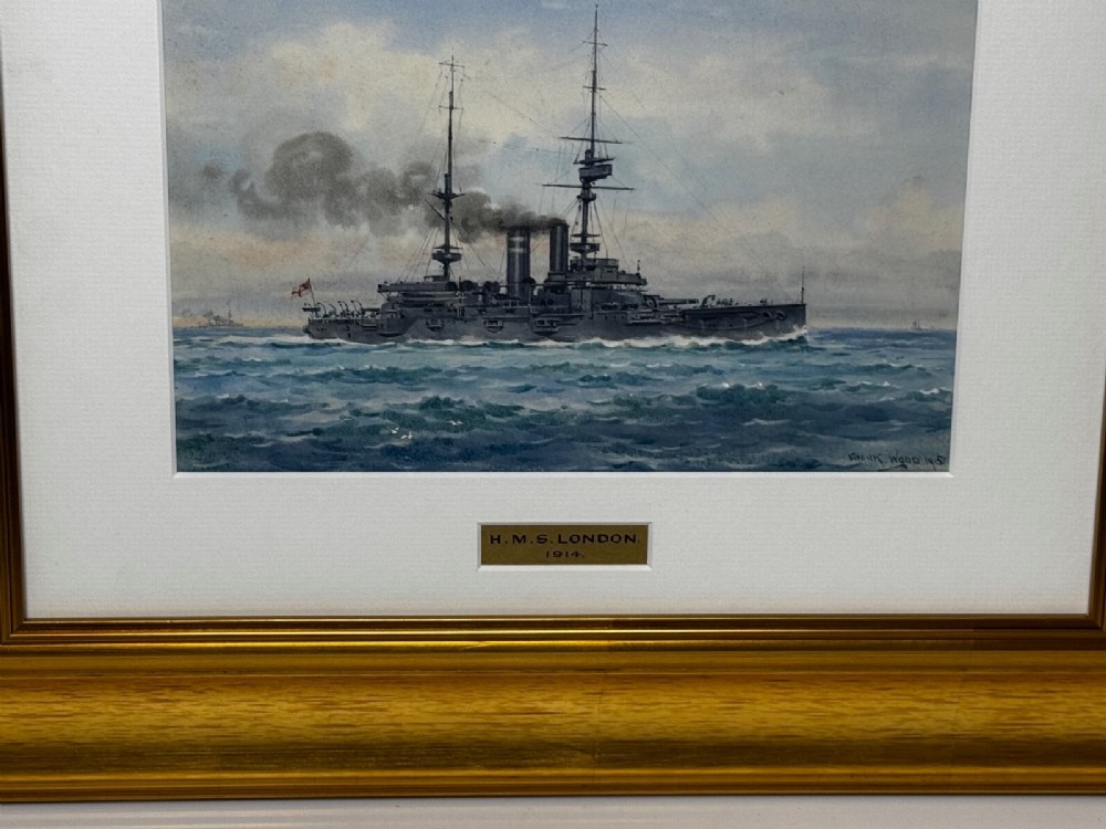 A framed watercolour painting depicting the WW1 battleship HMS London at sea, presented in a wide gold gilt frame with a white mount. View II