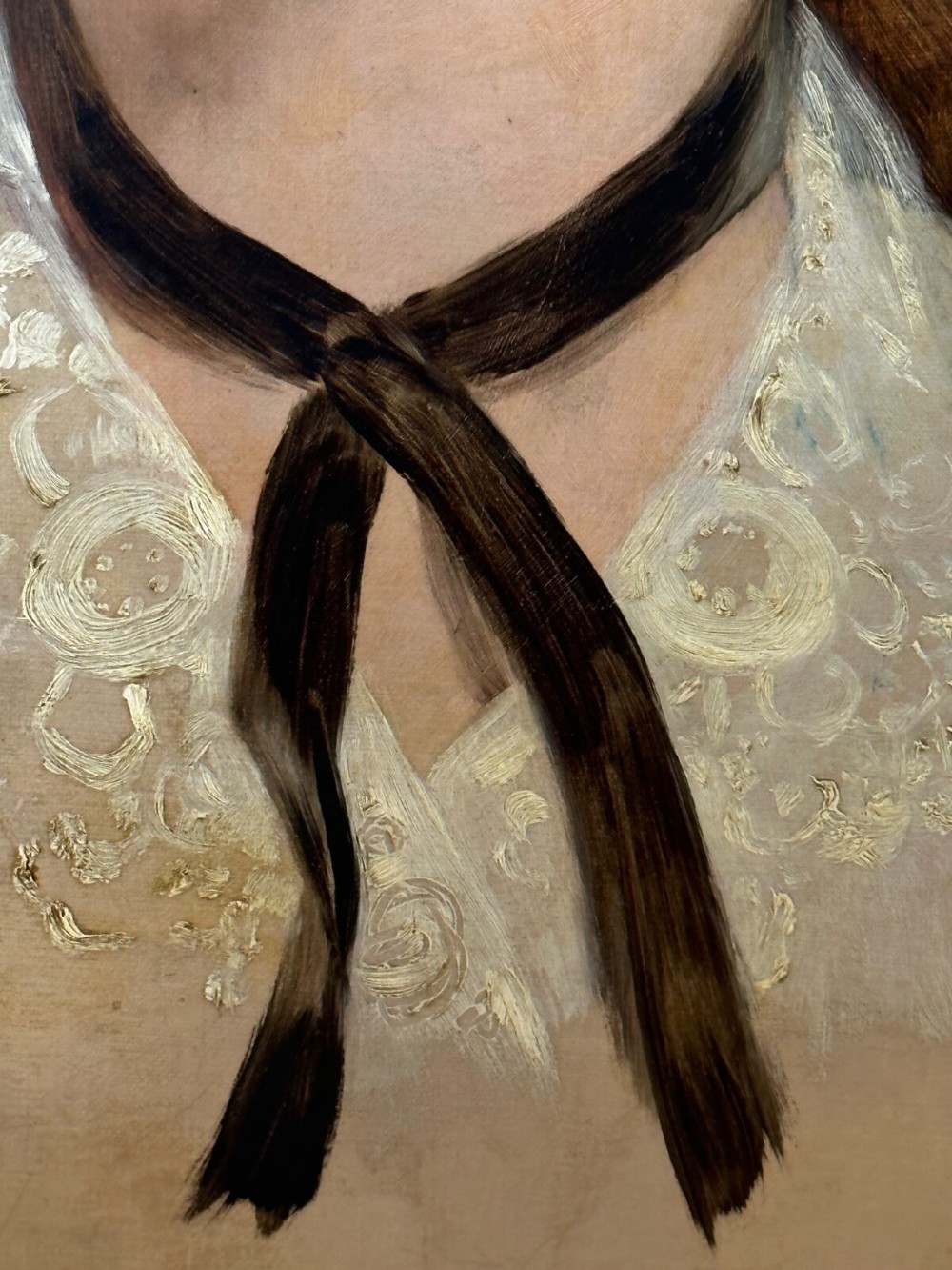 A Victorian oil painting on canvas depicting a young woman with dark hair tied with a black ribbon, displayed within an intricate pierced gold gilt frame with an oval aperture. View IX