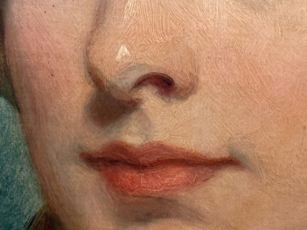 A Victorian oil painting on canvas depicting a young woman with dark hair tied with a black ribbon, displayed within an intricate pierced gold gilt frame with an oval aperture. View XII