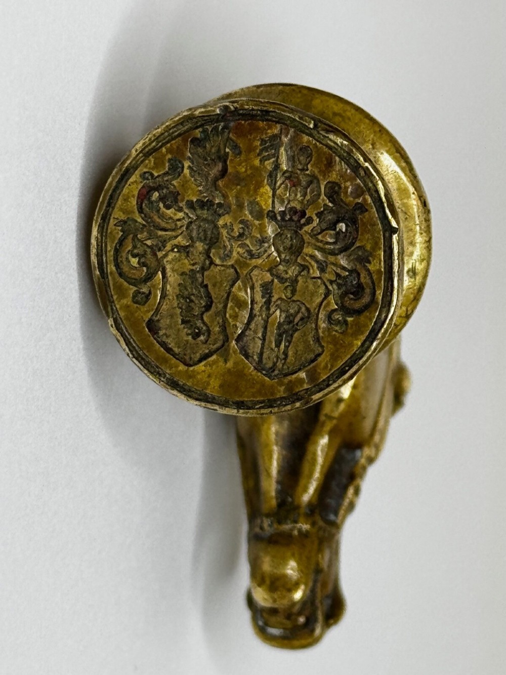 A cast brass Georgian desk seal sculpted in the shape of a detailed horse head above a rounded pedestal with an engraved intaglio base. View IV