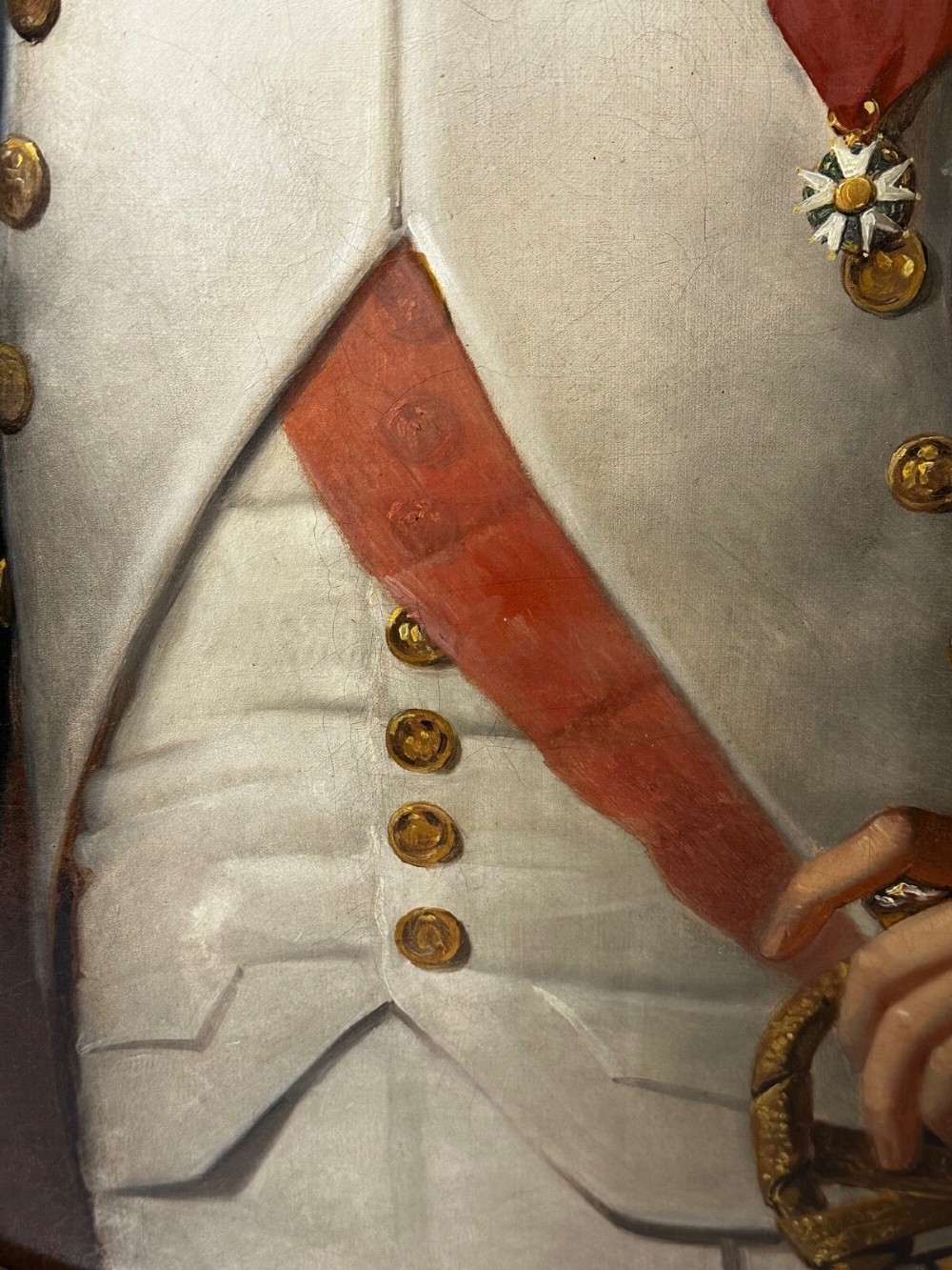 A 19th-century oil painting depicting Napoleon I in a military uniform within an oval spandrel and a rectangular gilded frame. View III