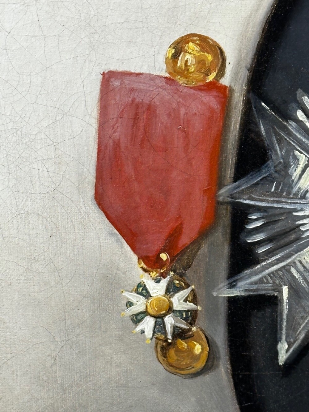 A 19th-century oil painting depicting Napoleon I in a military uniform within an oval spandrel and a rectangular gilded frame. View V
