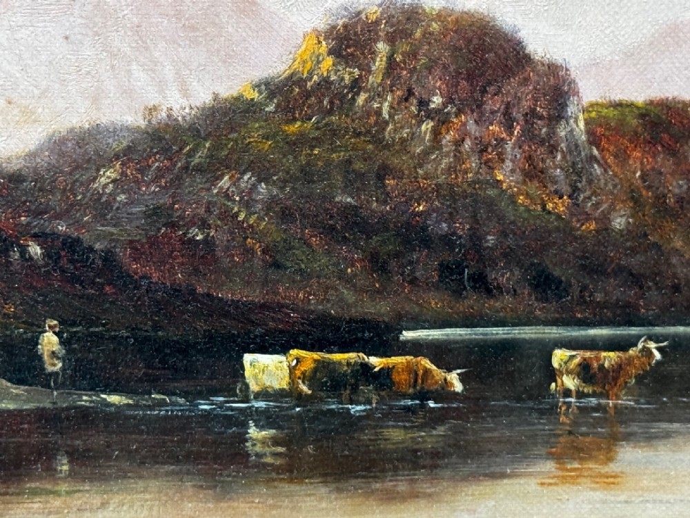 An antique oil painting depicting a lake surrounded by mountains at sunset, enclosed within a carved gold frame. View XI