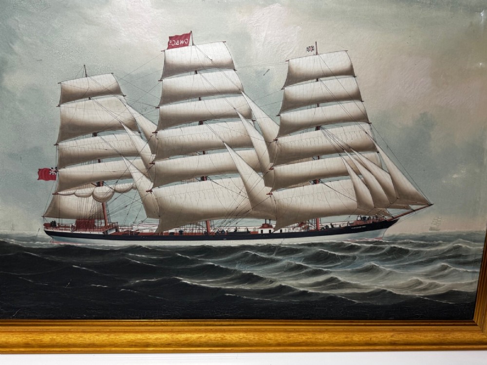 A framed oil painting depicting a three-masted sailing ship navigating dark blue seas under a cloudy sky within a gold gilt frame. View IV