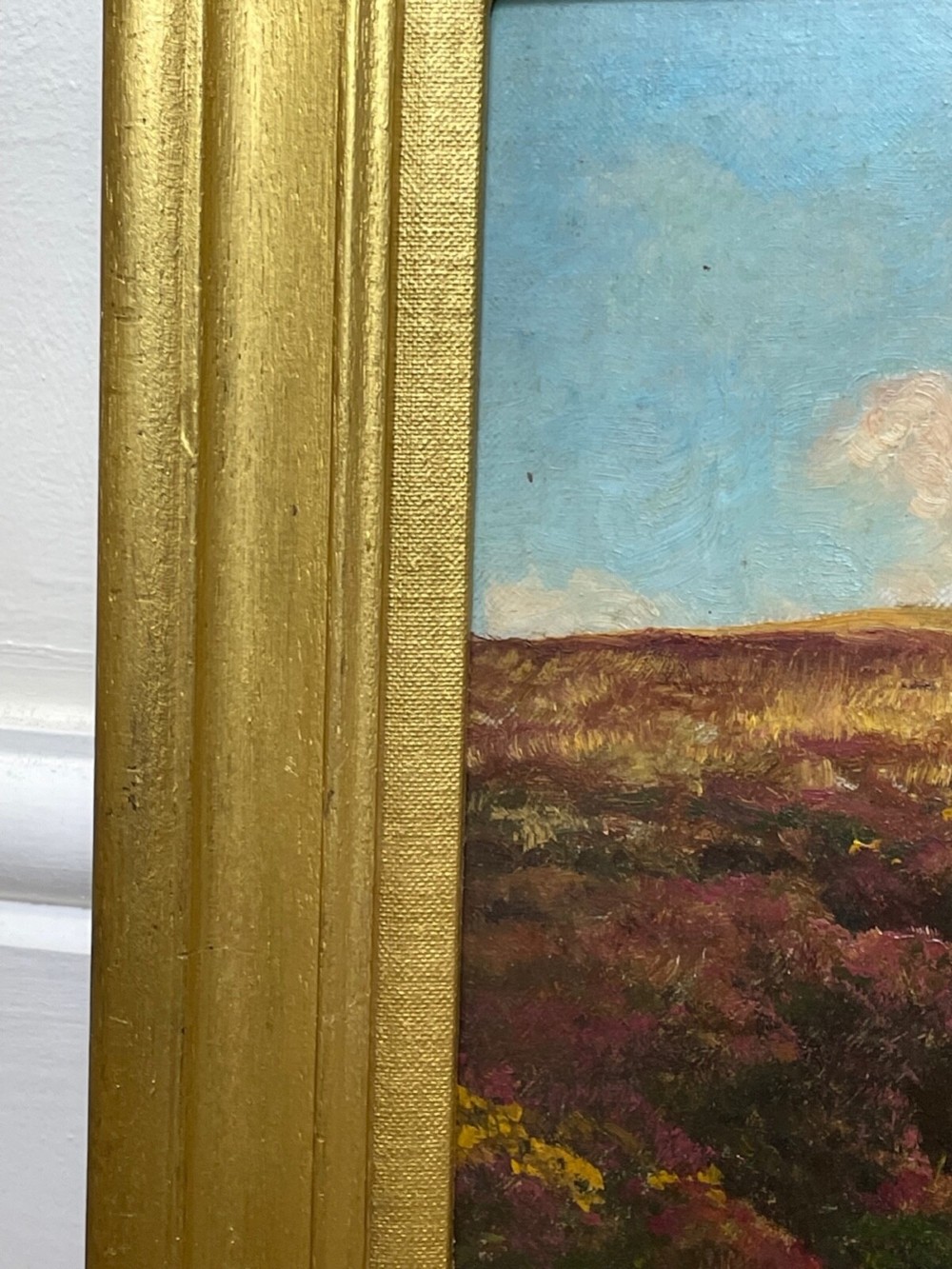 An oil painting depicting an open Exmoor moorland with purple heather under a blue sky, set within a wide gilded wooden frame. View X