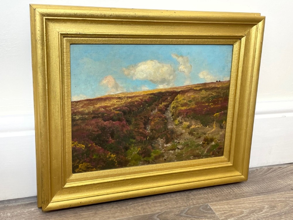 An oil painting depicting an open Exmoor moorland with purple heather under a blue sky, set within a wide gilded wooden frame. View XV