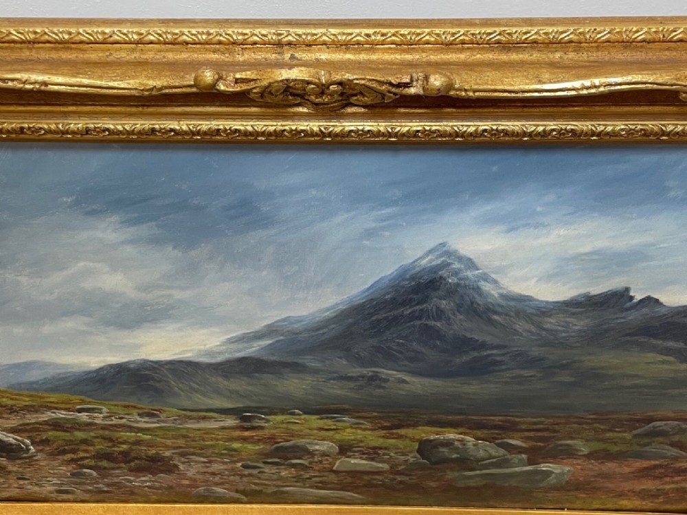 A Victorian oil painting depicting the mountain peak of Sgurr nan Gillean in Skye, housed in a wide ornate gold gilt frame. View IX
