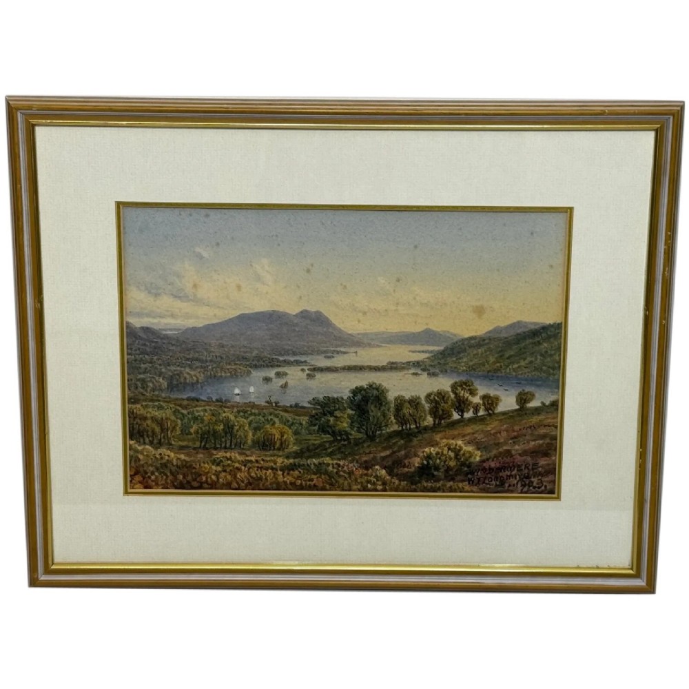An antique Edwardian watercolour painting depicting Lake Windermere with distant hills, trees, and small boats, framed in gilt with a cream mount.