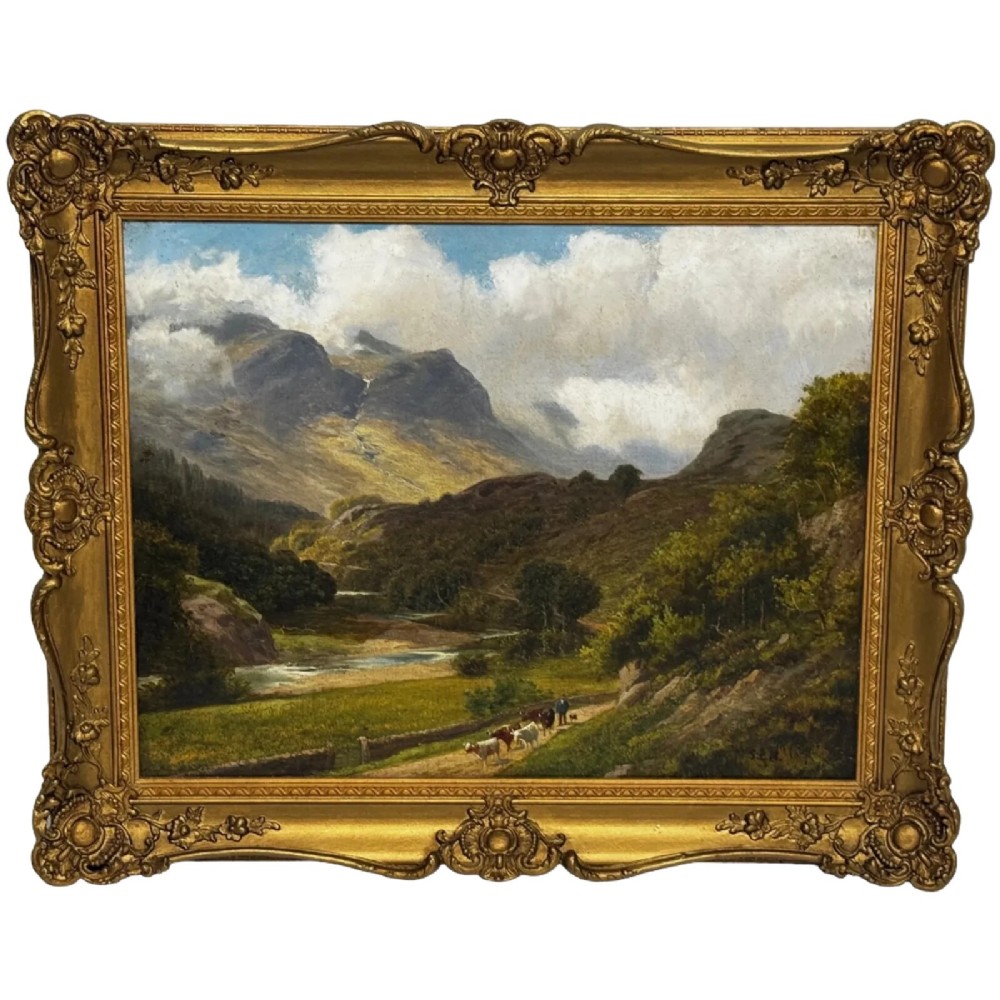 A Victorian landscape oil painting depicting a Cumbrian valley with mountains and cattle, set within an ornate gilded frame.