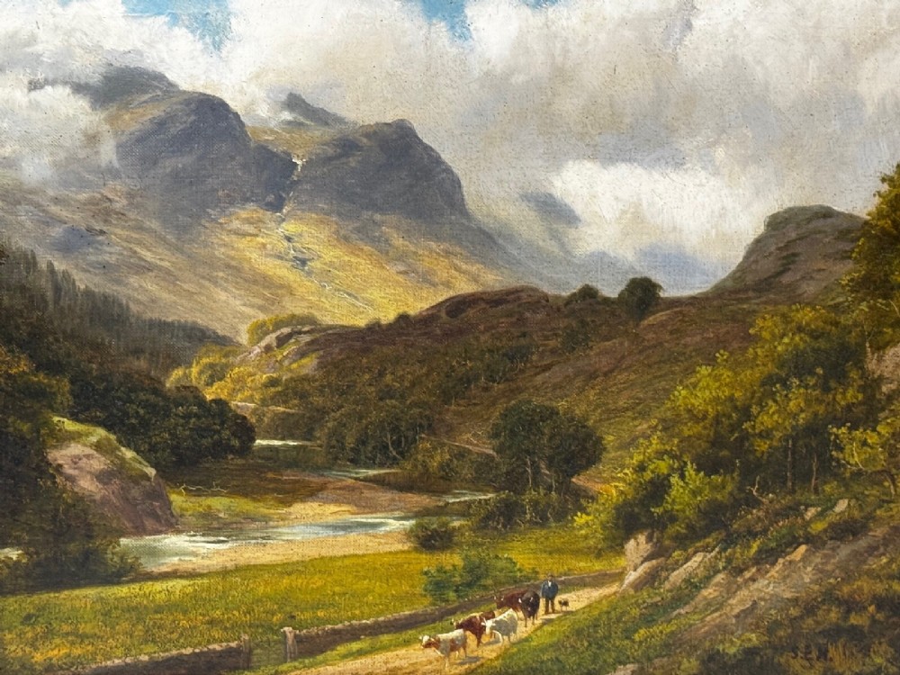 A Victorian landscape oil painting depicting a Cumbrian valley with mountains and cattle, set within an ornate gilded frame. View X