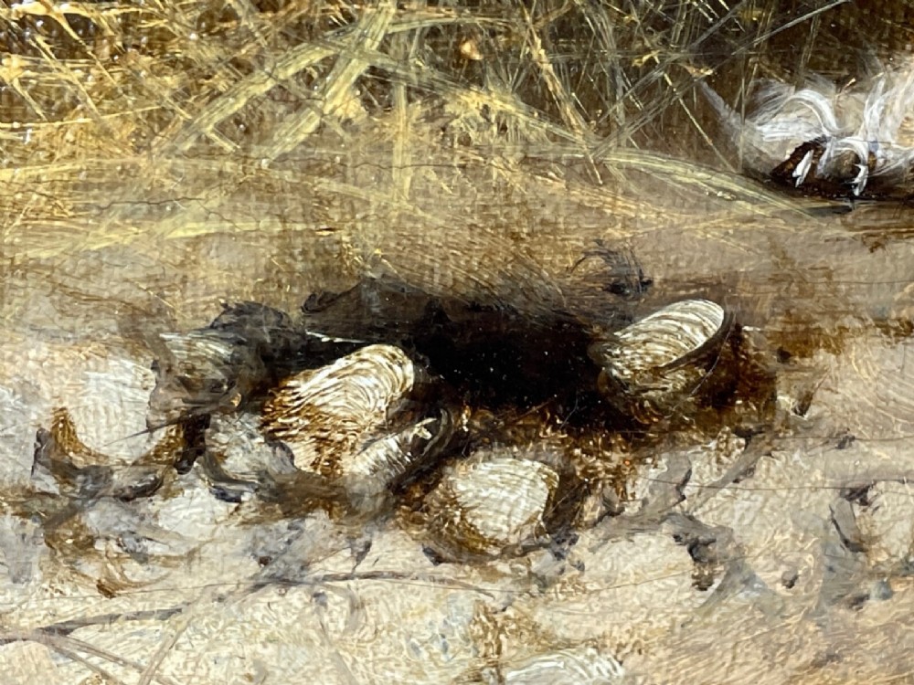 A 19th-century oil painting depicting three working terriers inside a straw-lined barn, presented in an ornate giltwood frame with detailed corner embellishments. View V