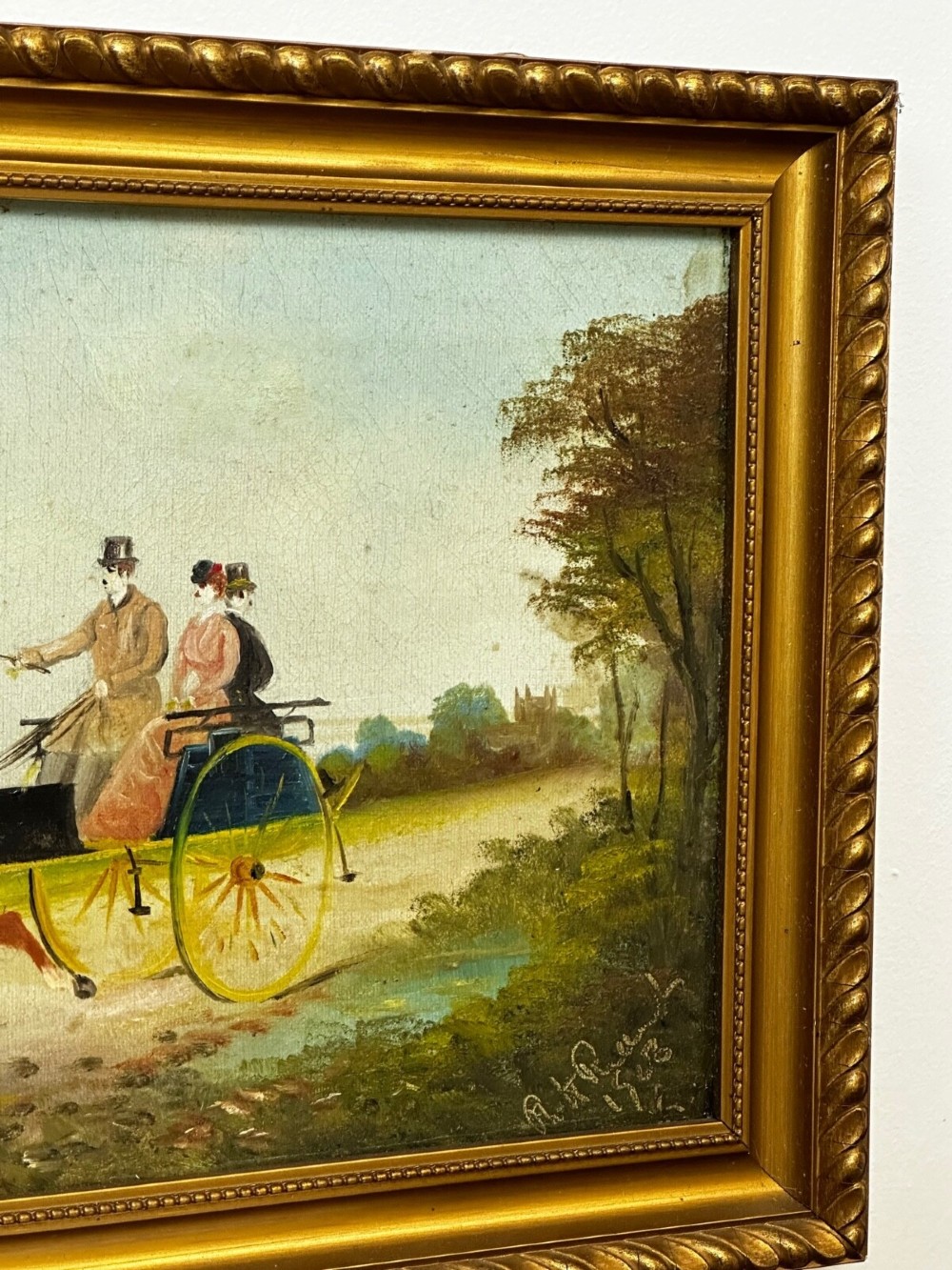 A rectangular framed oil painting depicting two horses drawing a carriage with passengers along a rural dirt road in a gilded twist-moulded frame. View XV
