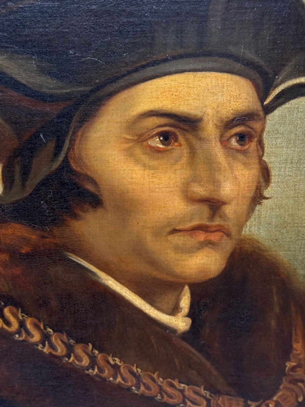 An oil painting on canvas depicting Sir Thomas More wearing a Tudor velvet cap and chain of office, enclosed within an ornate gilt wooden frame. View VII