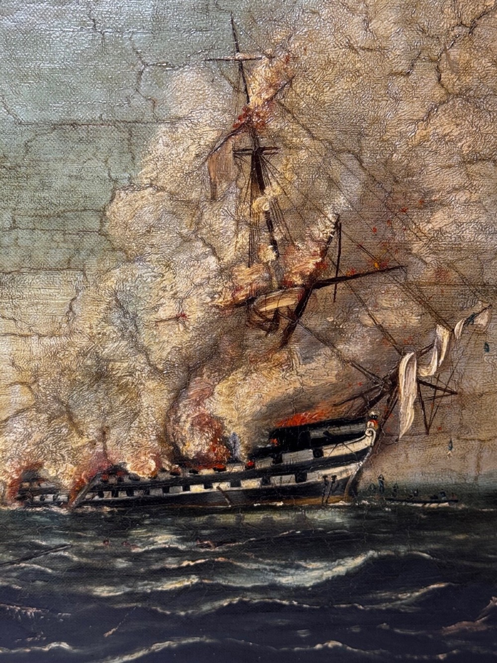 An antique oil painting depicting a burning nineteenth-century ship on a dark sea, enclosed in a heavily moulded gold gilt frame. View II