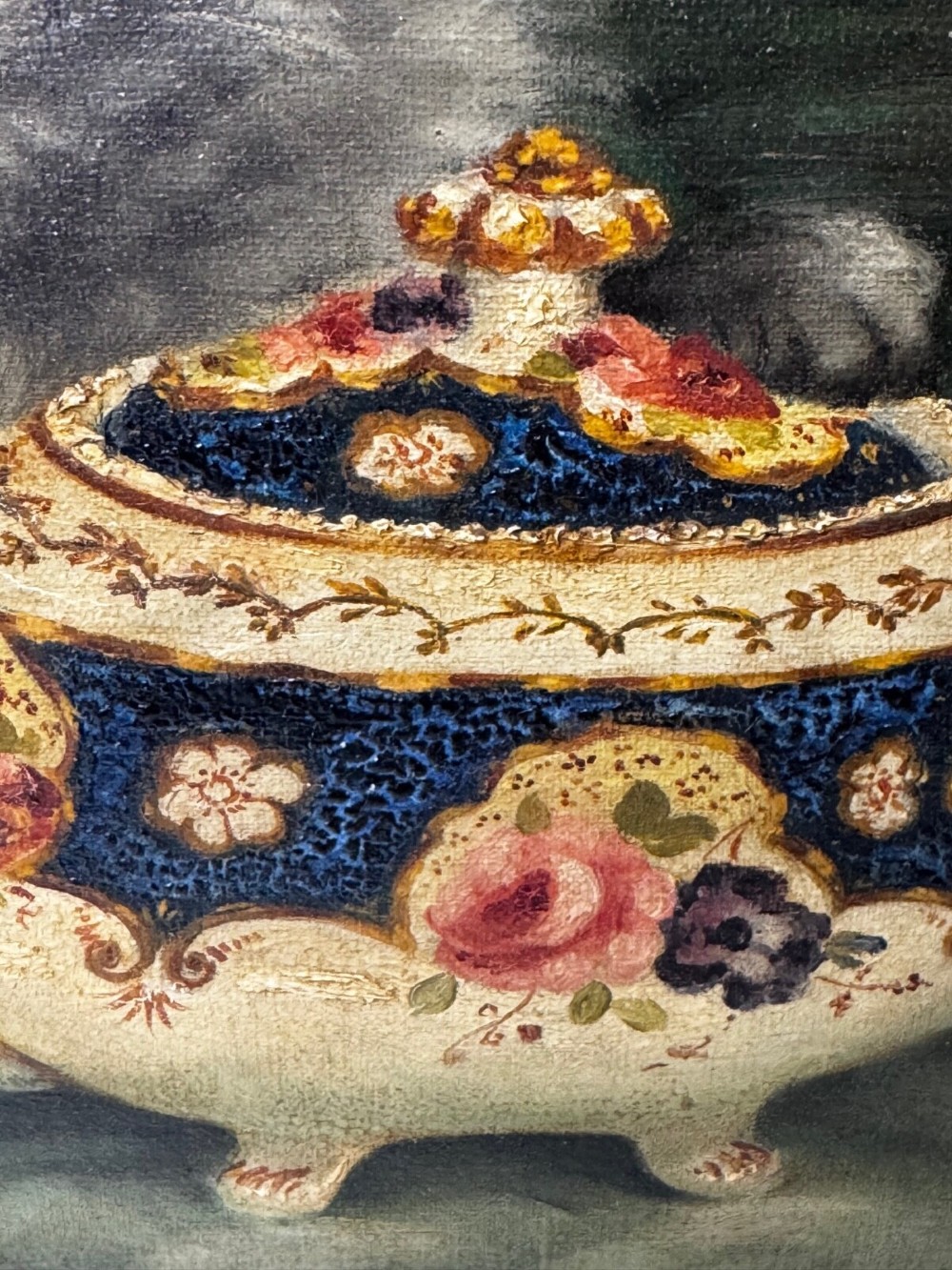 An antique framed oil painting depicting five grey and cream Persian kittens positioned around a wicker basket and a floral porcelain teapot. View IV