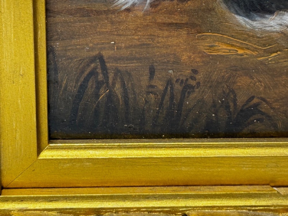 A nineteenth-century framed oil painting depicting a Blenheim spaniel and a tricolour spaniel seated outdoors, enclosed within an ornate gold giltwood frame. View IV