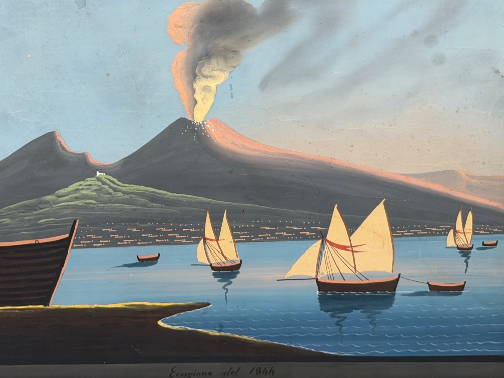 A framed 19th-century gouache painting depicting the eruption of Mount Vesuvius over the Bay of Naples with sailboats in the foreground. View VII