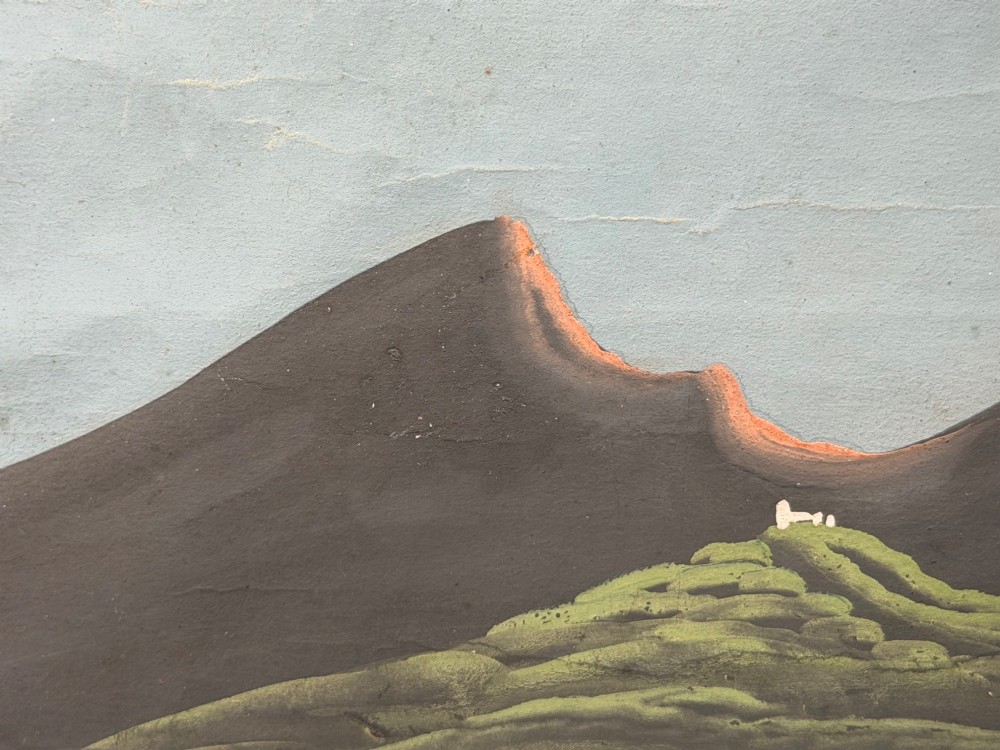 A framed 19th-century gouache painting depicting the eruption of Mount Vesuvius over the Bay of Naples with sailboats in the foreground. View XII