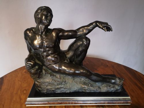 patinated bronze sculpture of a reclining male nude - CATEGORY: ANTIQUE SCULPTURES - DATED 1930