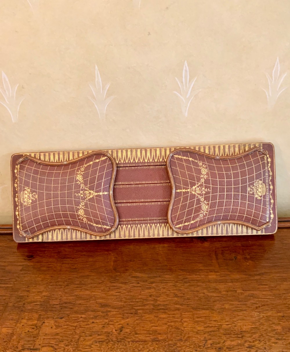 An early 20th century leather covered book slide 